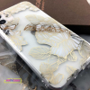 white iphone 11 with clear phone case with gold lines and white rose design